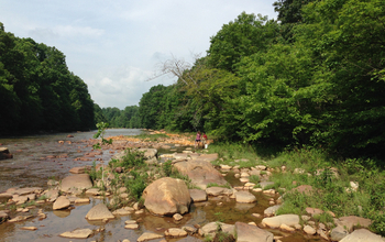 A disposal site in western Pennsylvania. showing a stream, a forest and two people